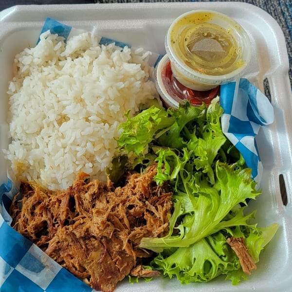 Kono's Hawaiian plate lunch with shredded pork, white rice, green salad, and two sauces.