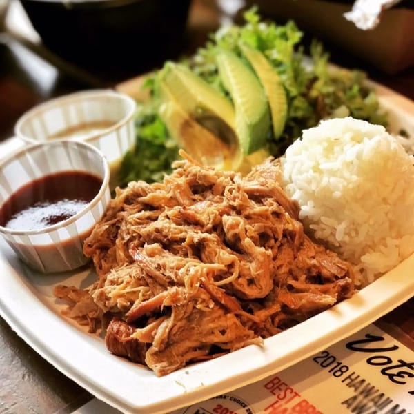 Kono's Hawaiian plate lunch with pulled pork, white rice, avocado, and green salad.